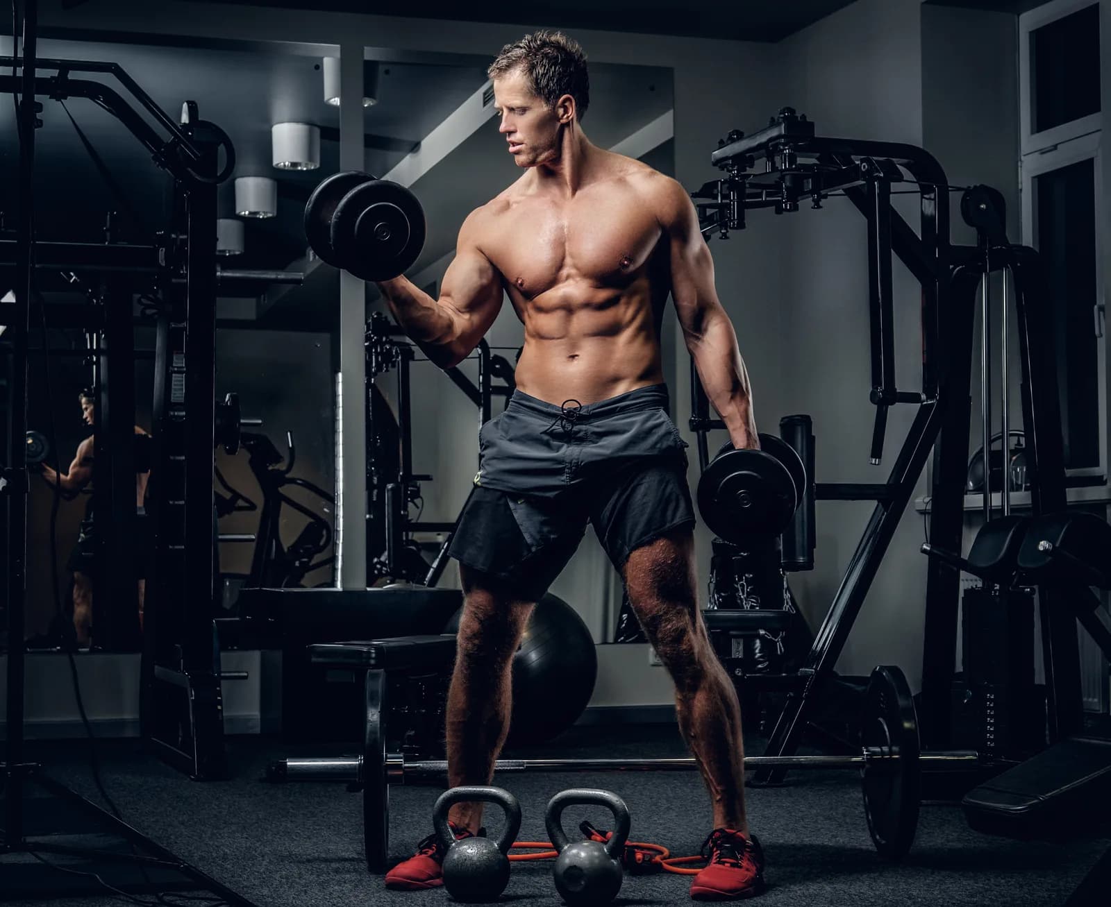 A man training with dumbbells in a gym